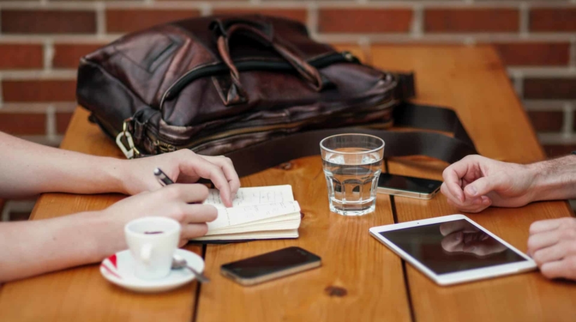 two person sitting in front of table