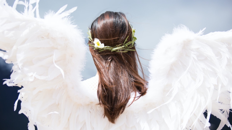 woman wearing white angel wings