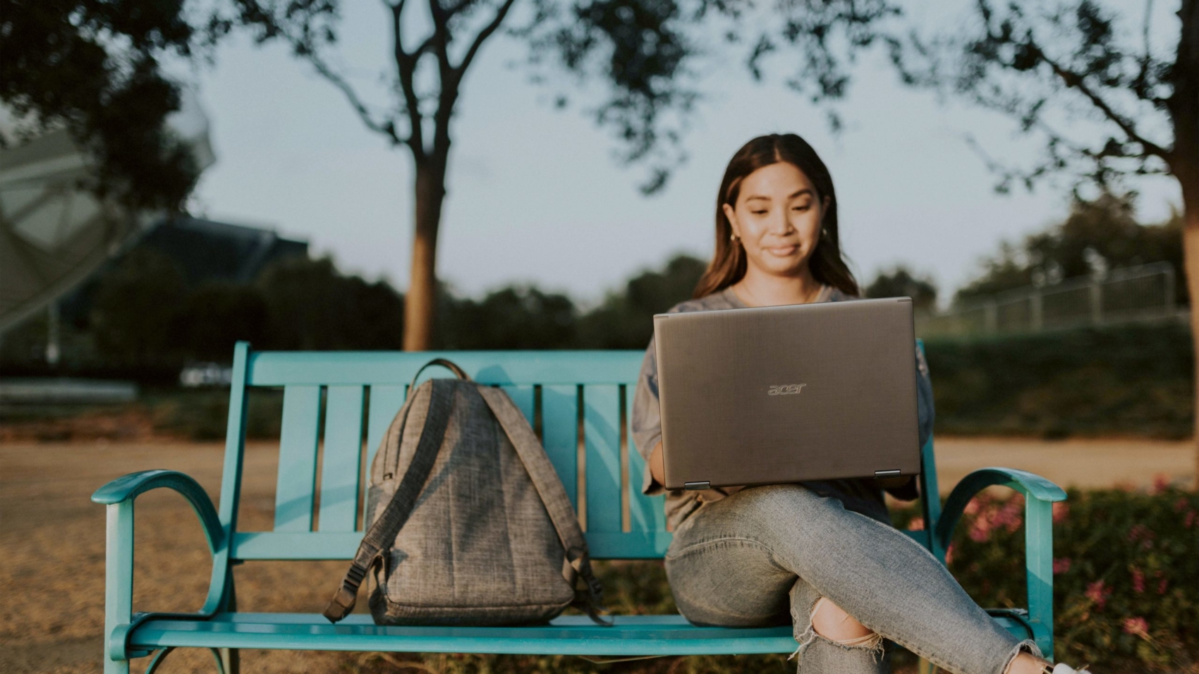 woman in brown long sleeve shirt sitting on blue metal bench