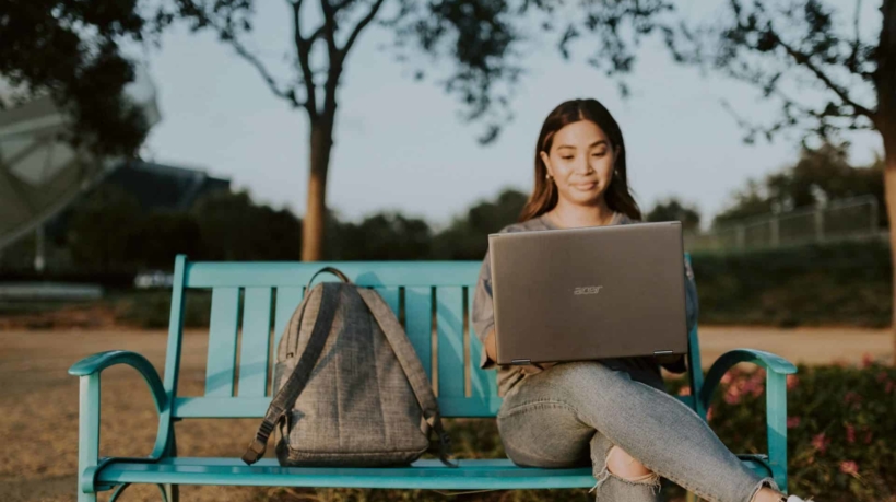 woman in brown long sleeve shirt sitting on blue metal bench